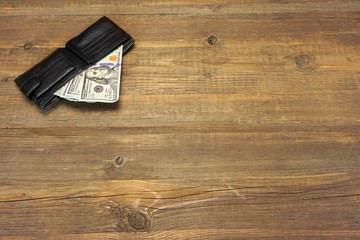 Men's Wallet With Dollar Cash On The Rough Wood Background