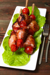 grilled barbecue kebab chicken legs and tomatoes on skewers