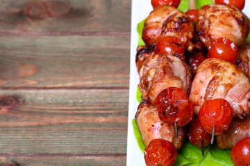 grilled barbecue kebab chicken legs and tomatoes on skewers