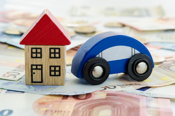 house, car and banknotes