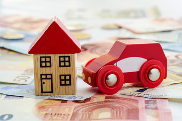 house, car and banknotes