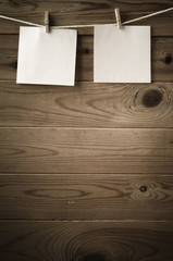 Blank Reminder Notes Pegged on String against Wood Planks