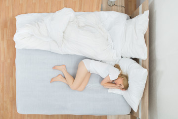 Woman Sleeping In Bedroom