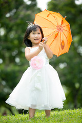 Portrait of asian girl in the park green background,