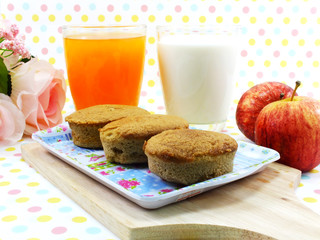 egg cake coffee flavor and red apple on sweet polka dot background