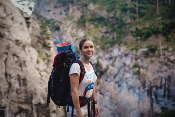 Caucasian hiker woman on trek in mountains with backpack living a healthy active lifestyle. Hiker girl on nature landscape hike in Crimea.