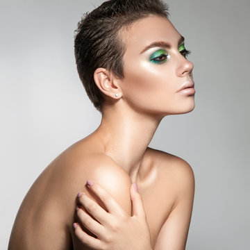 Perfect young woman with beautiful makeup and short hair looking