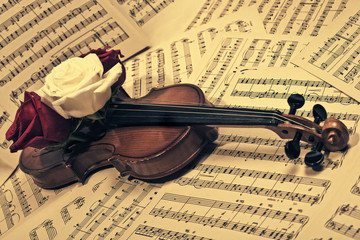old violin with musical notes and roses