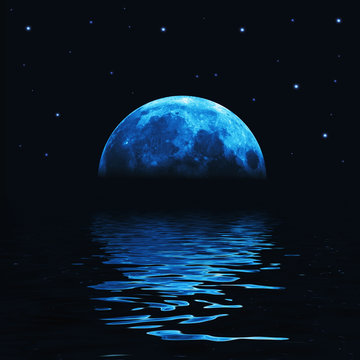 Big blue moon reflected in water