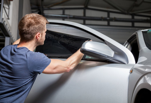 Applying Tinting Foil On A Car Window