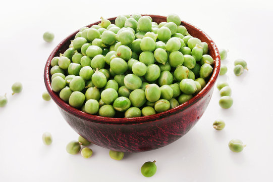 bowl of green peas on a white background