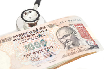 Stethoscope and indian 1000 rupee notes
