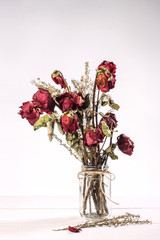 dried roses in glass vase