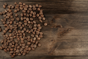 Background coffee. Roasted beans on old wooden background