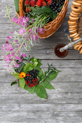 russian samovar on a rustic wooden table with berries and flowers