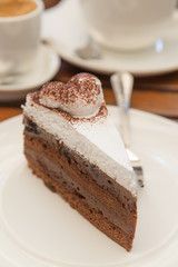 Chocolate cake with a cup coffee