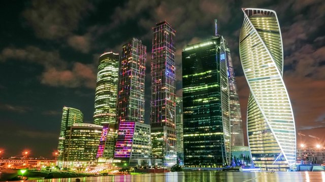 Moscow-City skyscrapers by night with cloud-drift on the