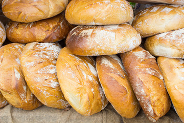 Freshly baked traditional loaves of rye bread on stall