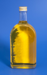 Oil In Glass Bottle On A Blue Background
