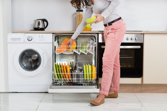 Woman Removing Bowls From Dishwasher