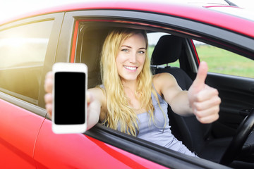 Fototapeta na wymiar Driver woman showing her smartphone.