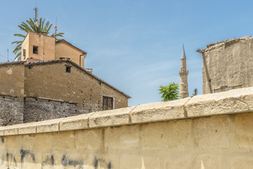 Walls around the old town of the Turkish section of Nicosia, Cyprus with a minaret tower of a mosque in the background.