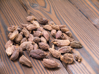 Amomum pods on the dark wooden textured planks
