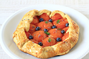 Simple crusty pie of short pastry with fresh apricots, blueberri