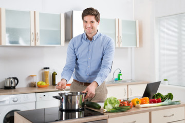 Man Cooking Food In Kitchen