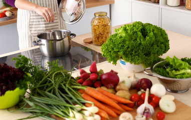 young girl is preparing vegetables in the kitchen