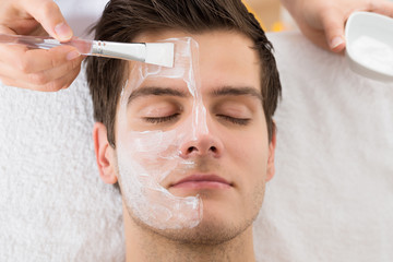 Therapist Applying Face Mask To Man