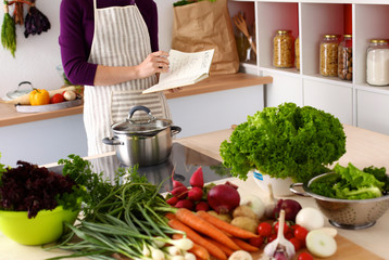 young girl is preparing vegetables in the kitchen