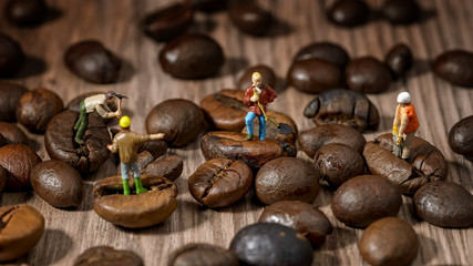 miniature workers on coffee beans
