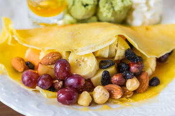 Pancake and fruit with ice cream on table