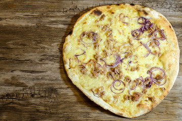 pizza onion and tuna on wooden table