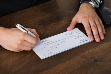 Person Hands Signing Cheque