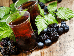 Hot black tea with berries, selective focus