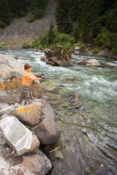 Child fishing in the river.