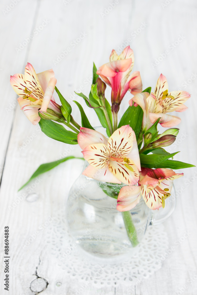 Wall mural flower alstroemeria in a glass vase