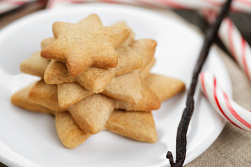 holiday cookies and candy canes on wood table
