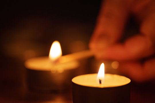 woman hand setting candle close up