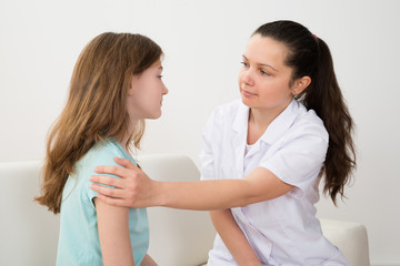 Female Doctor Comforting Girl