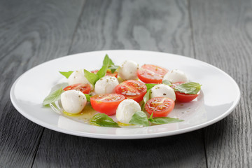 caprese salad with mini mozzarella balls and tomatoes