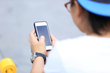 young skateboarder use cellphone sit on city stairs