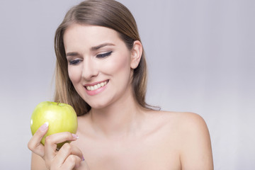Blonde woman smiling at the apple