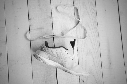 Close up of sport shoe and string on panel, black and white tone