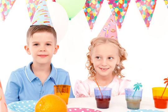 Little boy and girl during birthday party 
