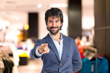 Fototapeta premium Man pointing to the front over white background