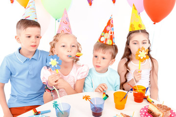 Children posing with birthday party equipment