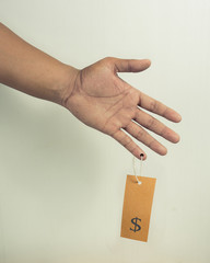 Trafficking concept. A hand with price tag
